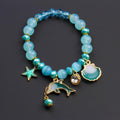 Pulsera de cuentas con dije de delfín y concha marina