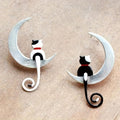 Pendientes asimétricos de gato en la luna