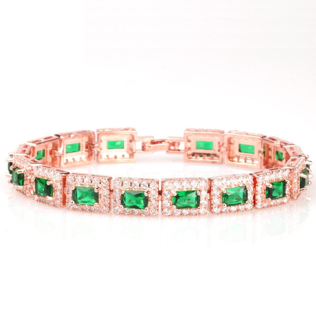 Pulsera llamativa dorada con esmeraldas