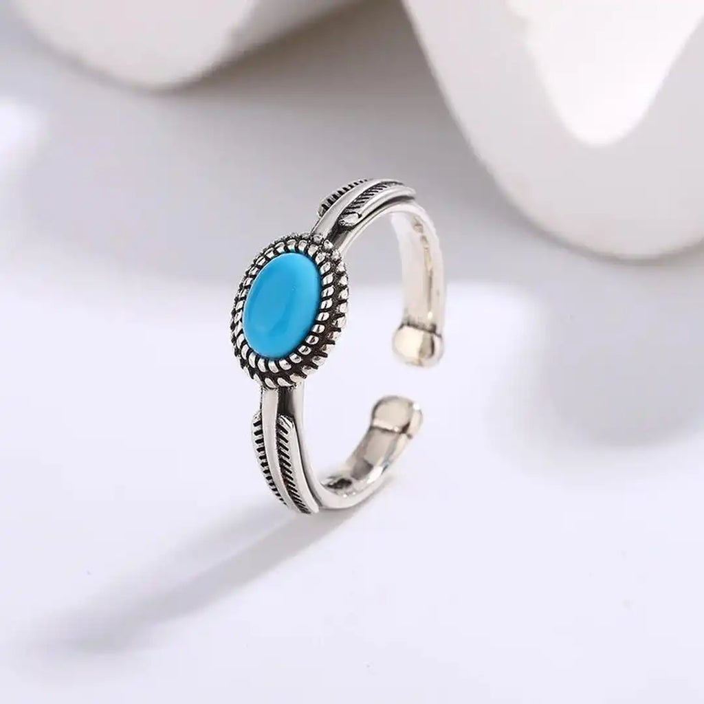 Anillo de plumas turquesas ajustable de plata