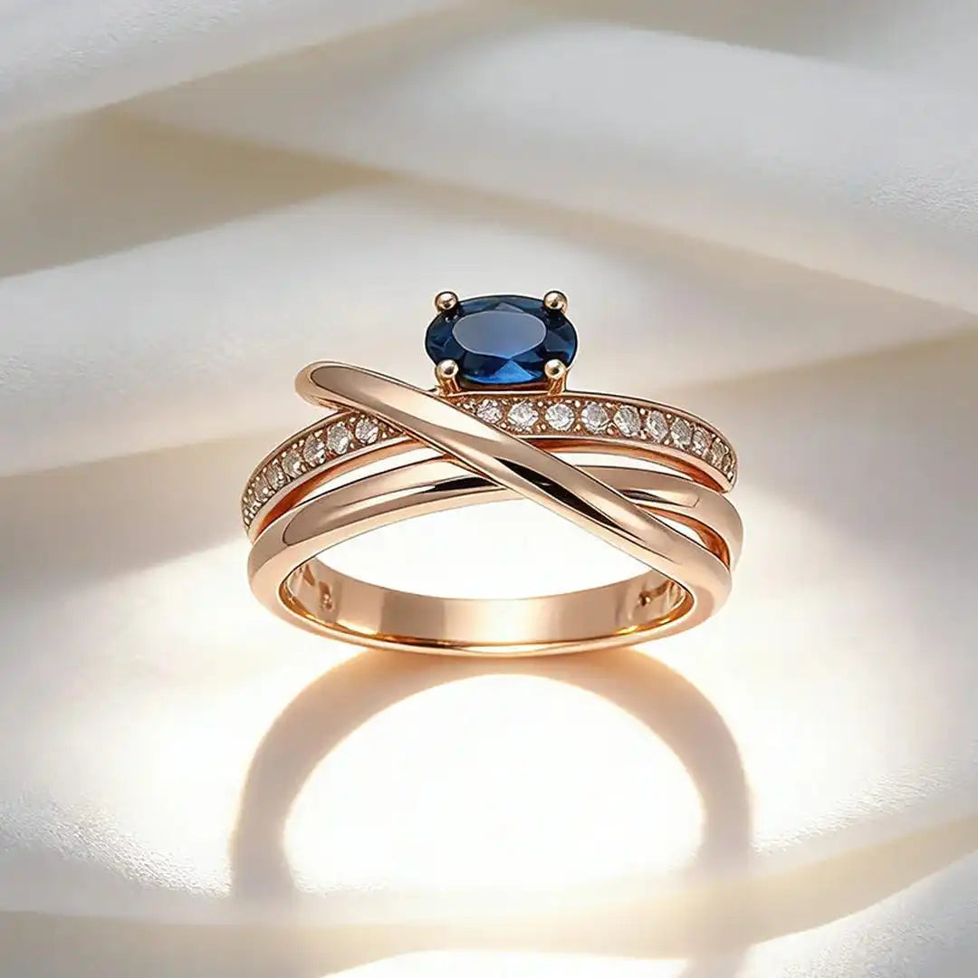 Anillo vintage de oro rosa con circonitas cúbicas azules y forma de cruz