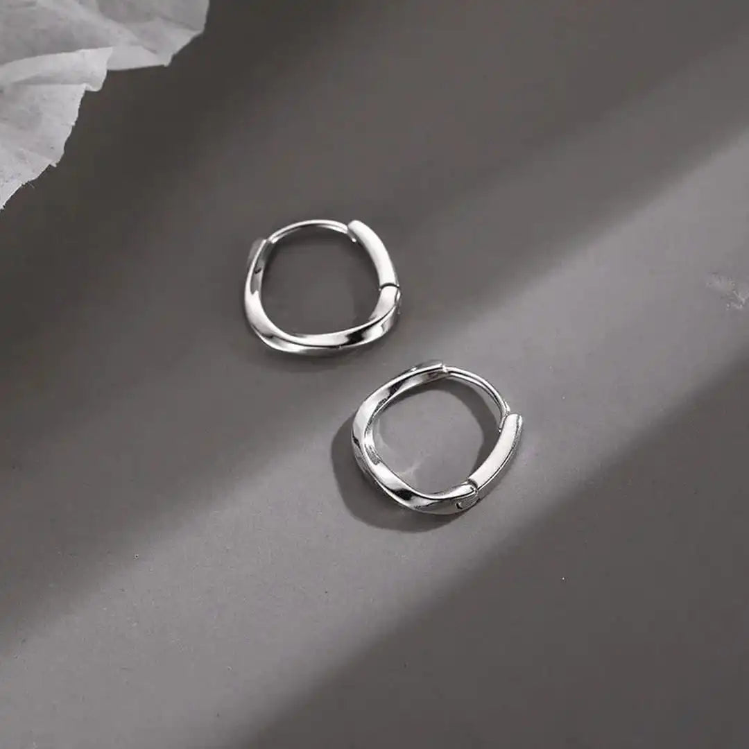 Aretes redondos con incrustaciones de plata de ley