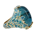 Elegante anillo de flor dorada con piedra azul