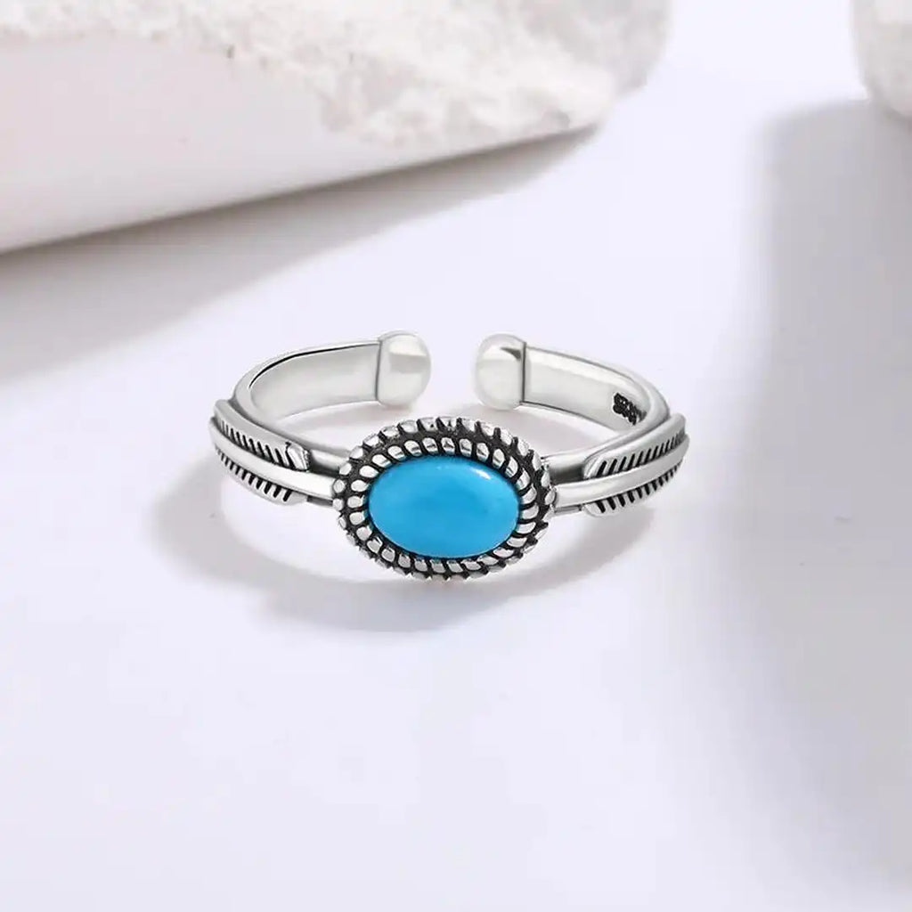 Anillo de plumas turquesas ajustable de plata