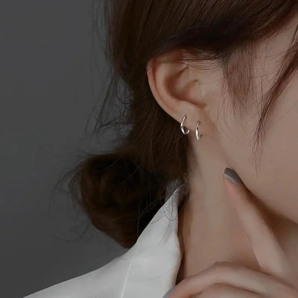 Aretes redondos con incrustaciones de plata de ley