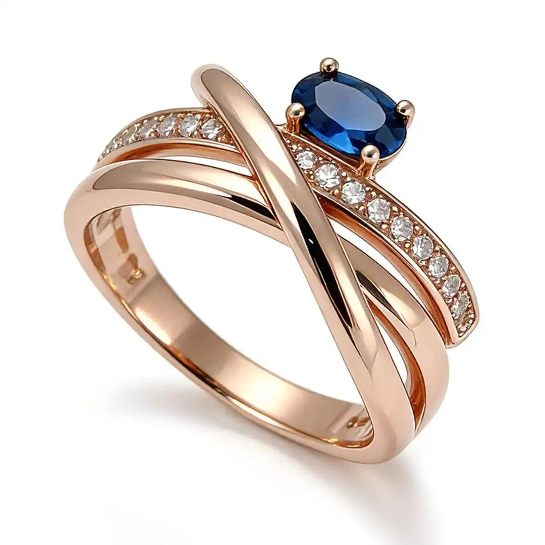 Anillo vintage de oro rosa con circonitas cúbicas azules y forma de cruz