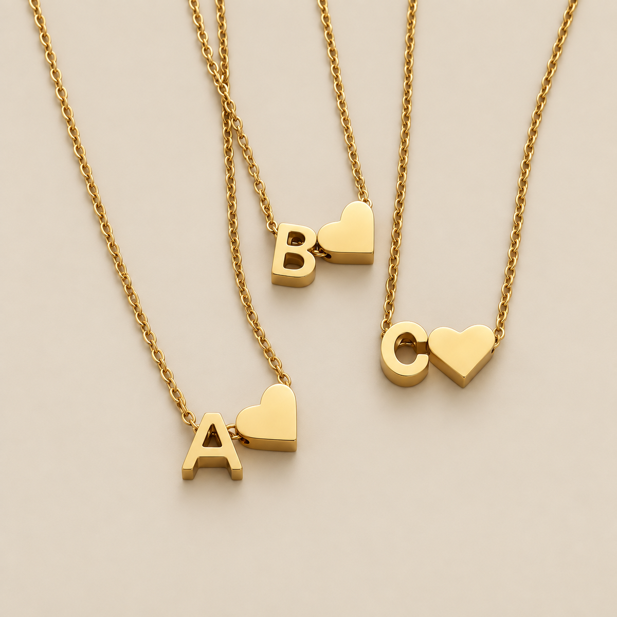 Personalized Gold Initial Heart Necklace — cream studio photograph