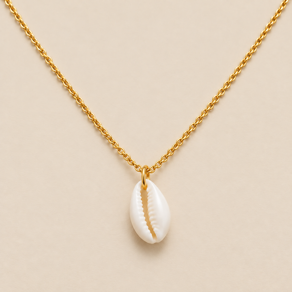Collar con colgante de concha de cauri sobre fondo crema