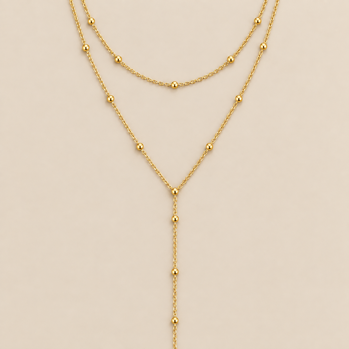 Gold Double Layered Long Tassel Beads Necklace — cream studio photograph