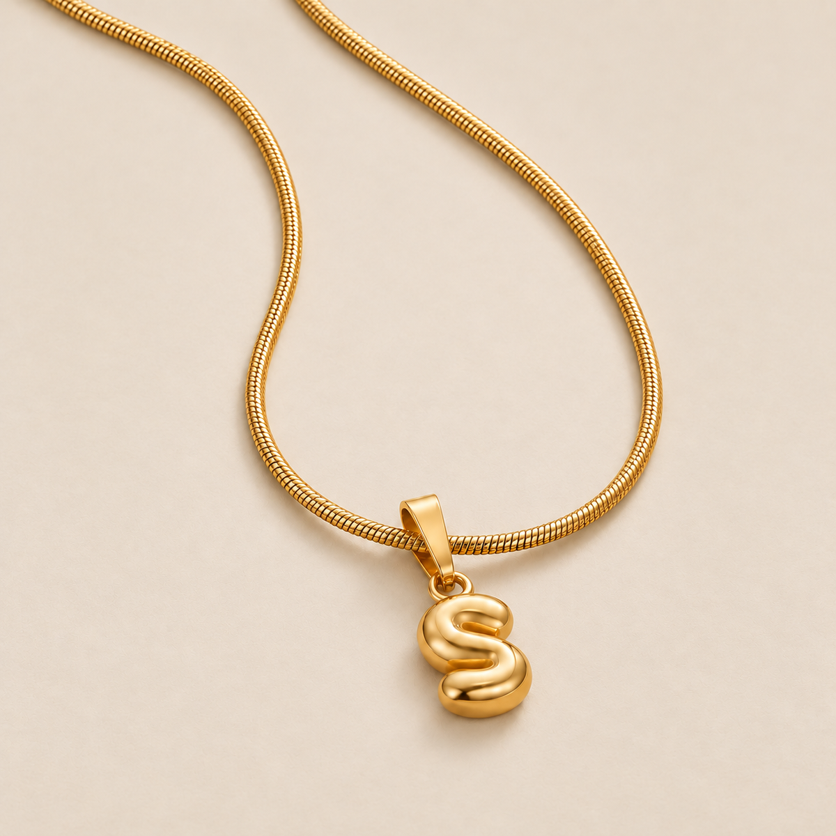 Trendy Bubble Letter Pendant Necklace — cream studio photograph
