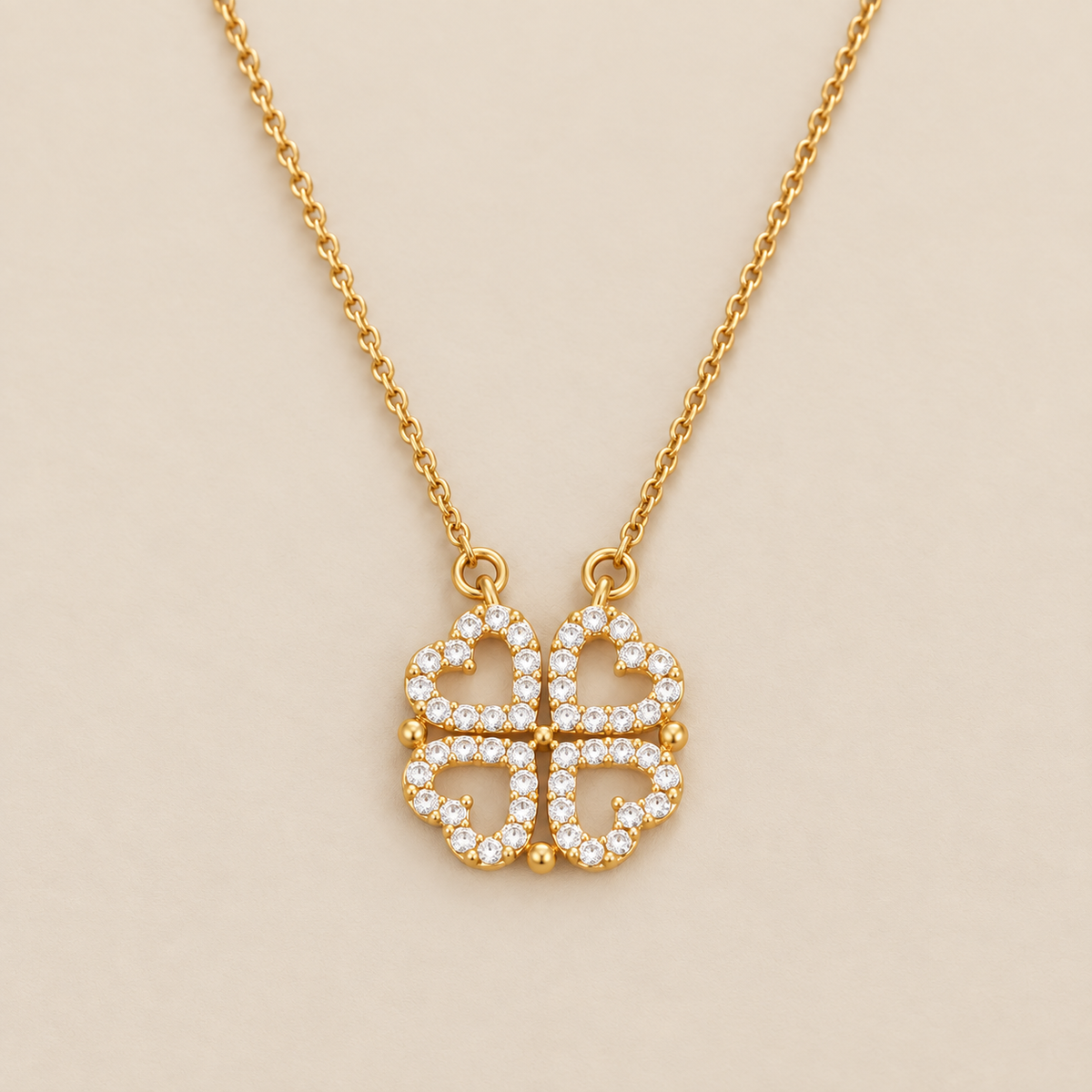 Golden Clover Necklace with Zircon Stone Heart Pendant — cream studio photograph