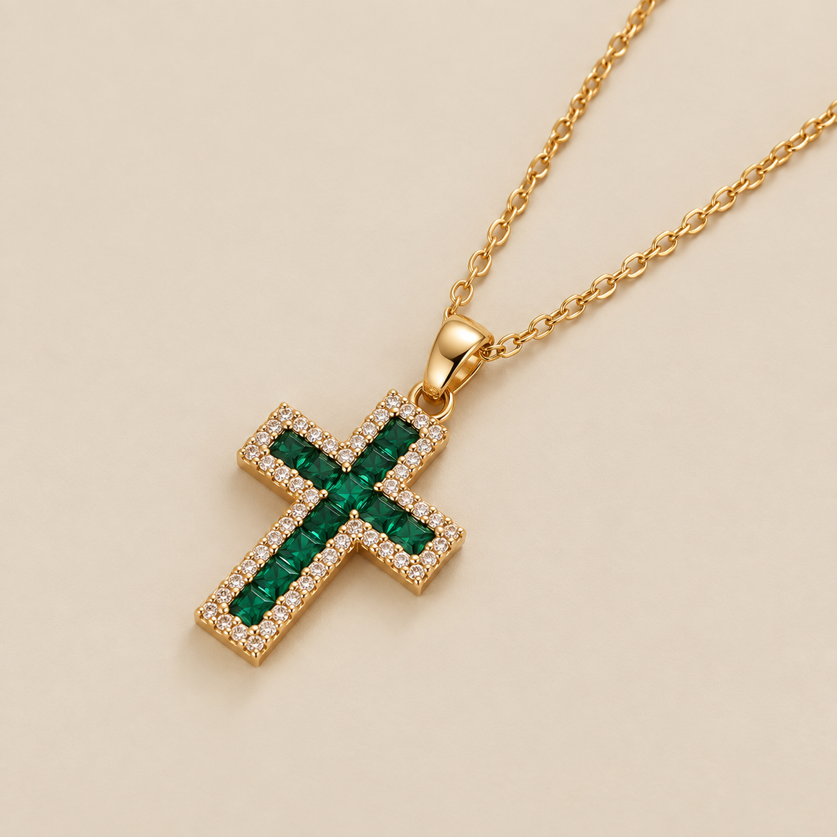 Emerald Cross Pendant Gold Necklace — cream studio photograph
