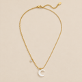 White Crescent Moon Necklace — cream studio photograph