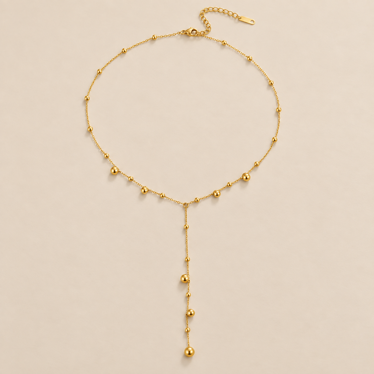 Lovi Gold Beads Tassel Necklace — cream studio photograph