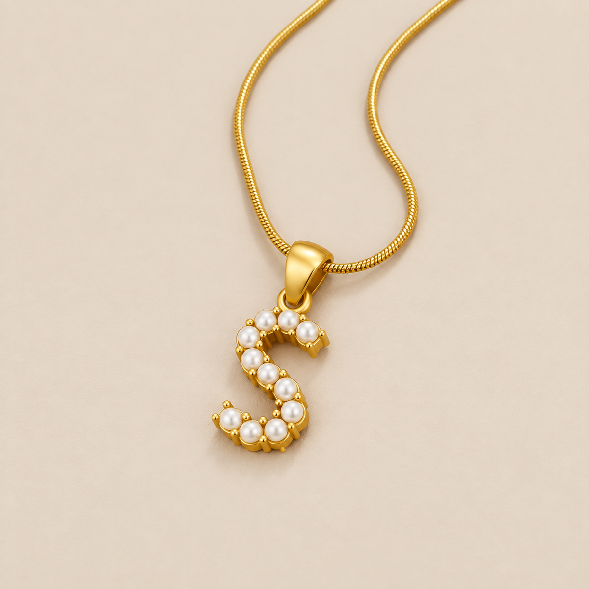 Letter Pearl Charm Necklace — cream studio photograph