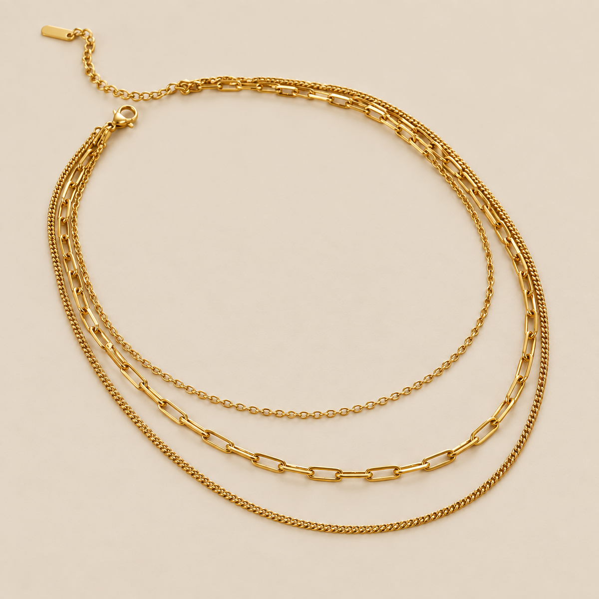 Everyday Triple Gold Necklace — cream studio photograph