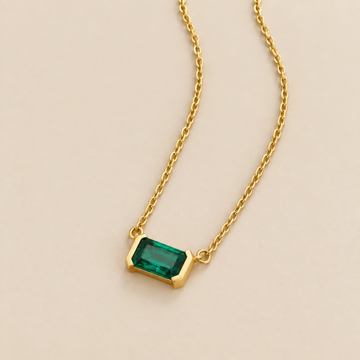 Green Emerald Golden Necklace — cream studio photograph