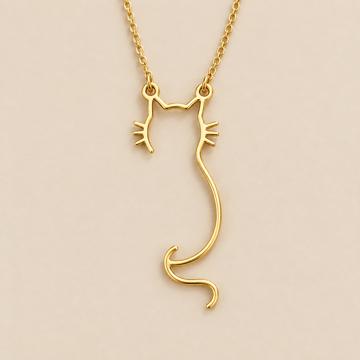 Gold Cat Silhouette Pendant Necklace — cream studio photograph