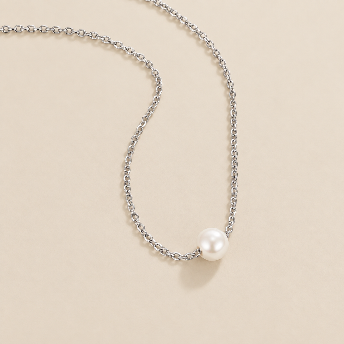 Solitaire Silver Pearl Necklace — cream studio photograph