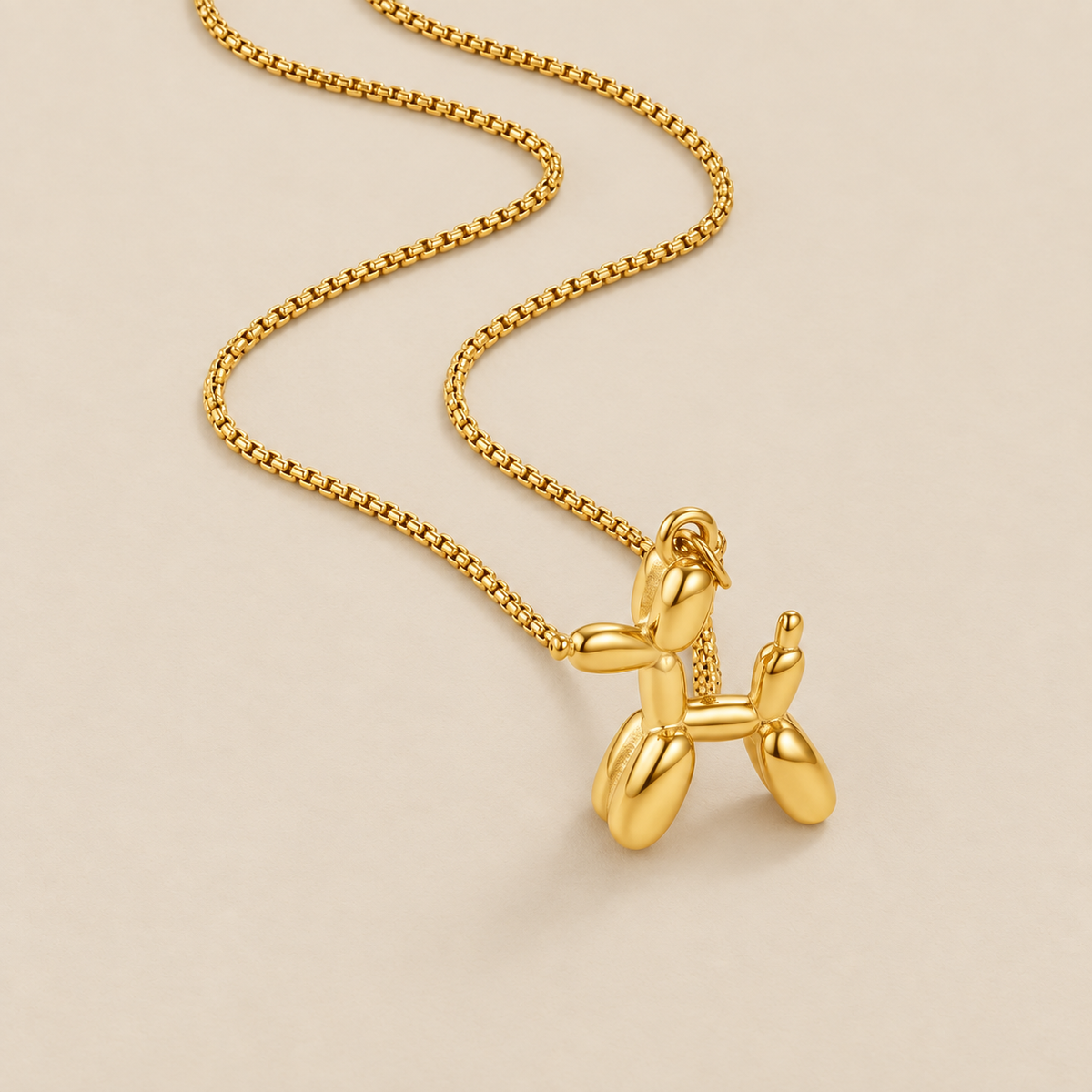 Gold Balloon Animal Necklace — cream studio photograph