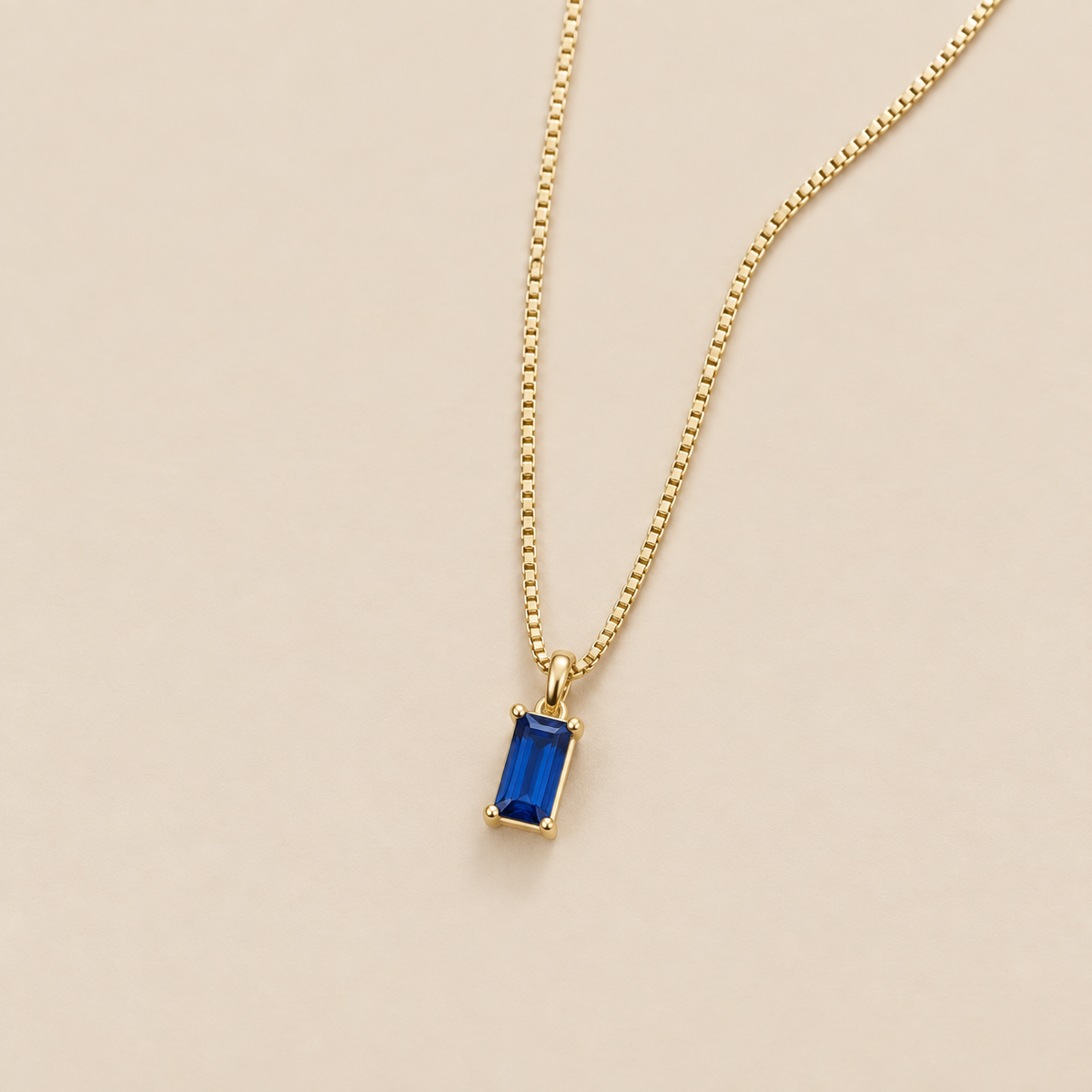 Minimalist Sapphire Pendant Necklace — cream studio photograph