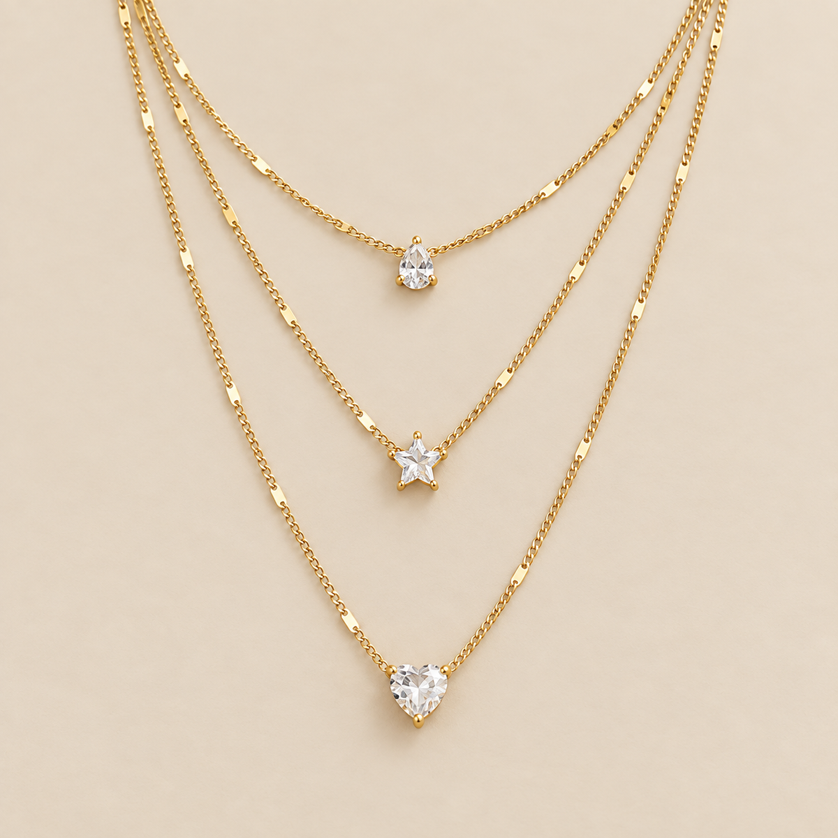 Triple Pendant Necklace with Gold Zirconia — cream studio photograph