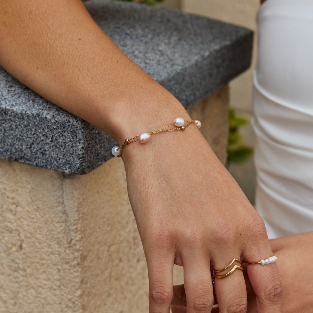 Pulsera de perlas de agua dulce en la muñeca de una modelo