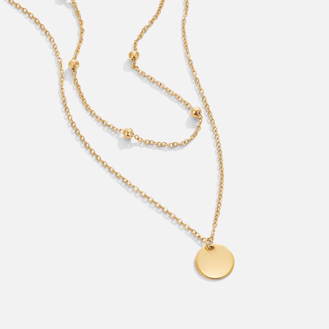 Collar con colgante de disco de oro en capas