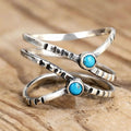 Anillo de cruz con piedra turquesa infinita